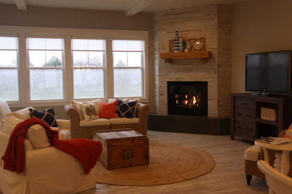 Luxury Vinyl Plank Wood Flooring in a Living Room with Ceramic Tile Corner Fireplace