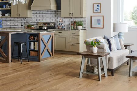 Bright kitchen with durable flooring and comfortable living space | DeGraaf Interiors