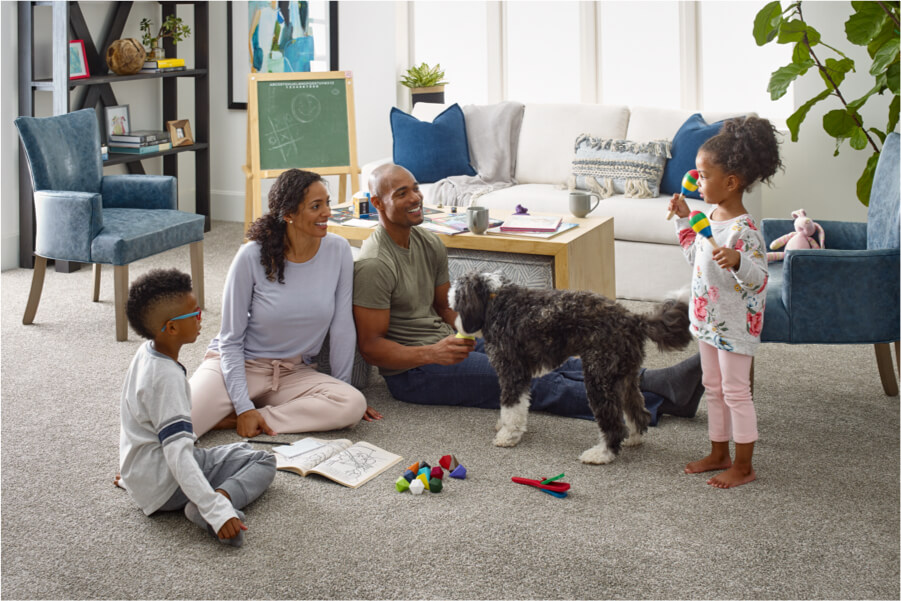 Family enjoying time together in a home with comfortable flooring | DeGraaf Interiors